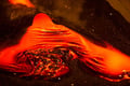 Bright red molten lava flowing during a live demonstration that recreates the intensity of a volcanic eruption in Iceland.