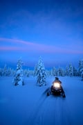 Driving a snowmobile through the Arctic wilderness