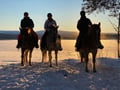 A small group horseback riding tour in the snow