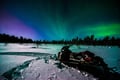 Searching for Northern Lights by Snowmobile