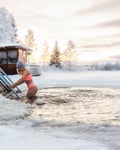 A woman going into an ice plunge