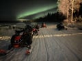 Chasing the Northern Lights by snowmobile and homemade dinner