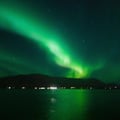 Vibrant Northern Lights glowing above the sea in Iceland