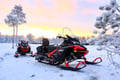 Feel the speed of snowmobiles in the middle of winter forest