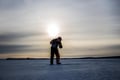Ice Fishing on frozen lake in Levi