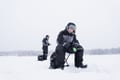 Ice Fishing on frozen lake in Levi