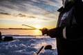 Ice Fishing on frozen lake in Levi
