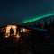 Watching the Northern Lights from a campfire on a reindeer pasture in Rovaniemi
