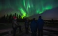 Watching the Northern Lights from a campfire on a reindeer pasture in Rovaniemi
