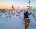 Horse trail riding to the snowy hill