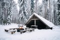 Laavu shelter and fire in a snowy forest near Rovaniemi, Lapland